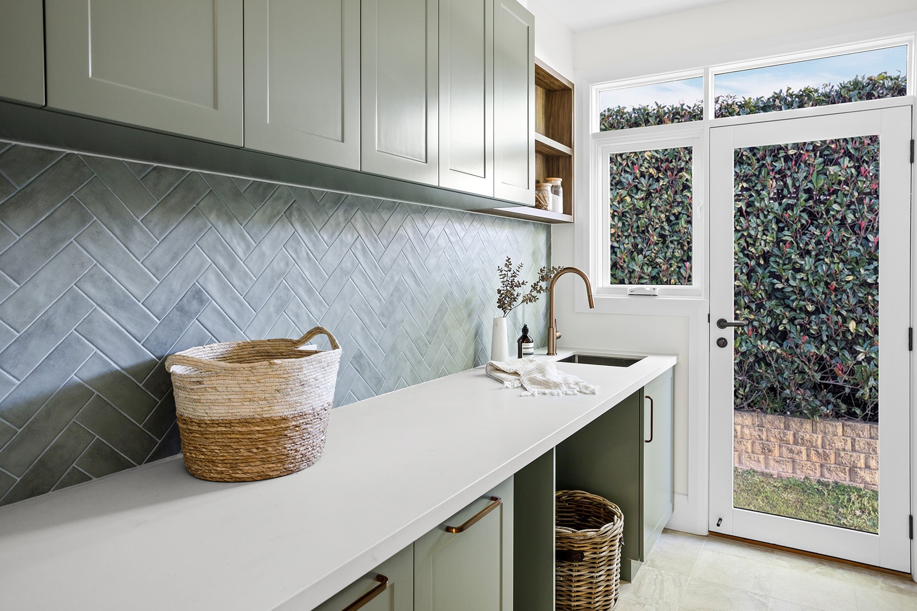 Laundry room featuring white timber hinged doors with clear glass panels, bringing in natural light